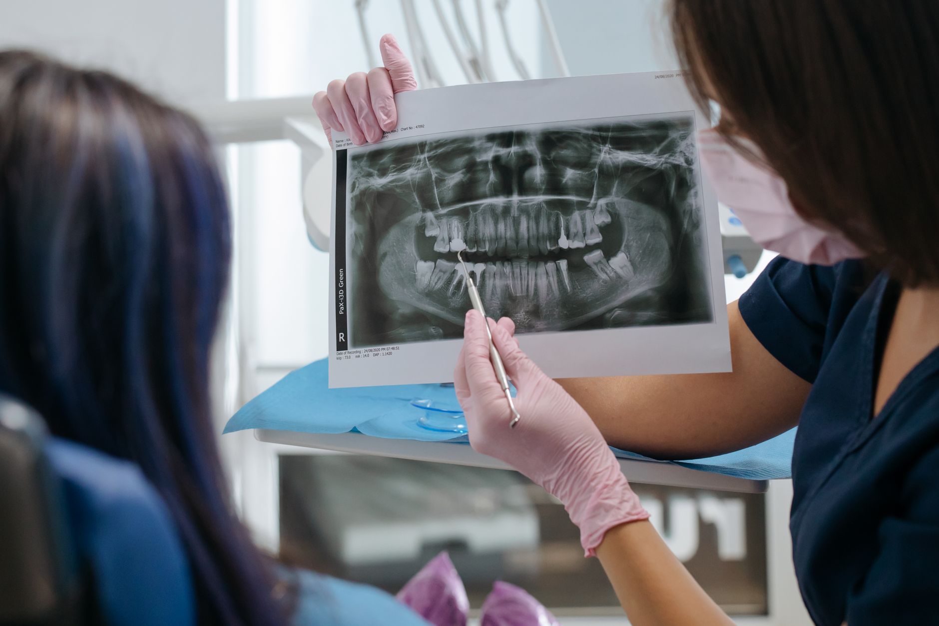 Patient discussing root canal and tooth extraction with the dental team in Sainte-Julie