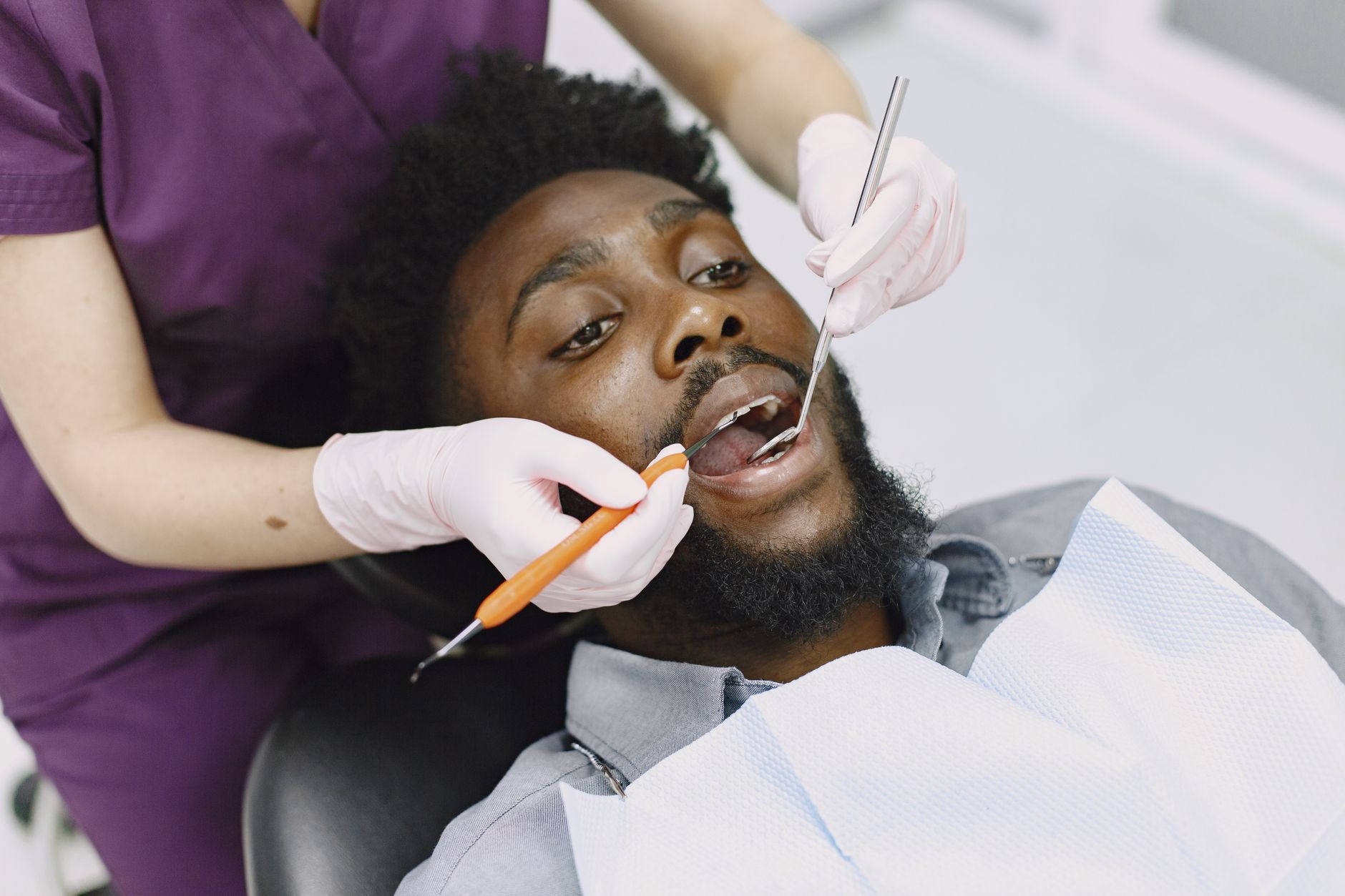Dentist examining a patient's gums during a routine checkup in a dental clinic