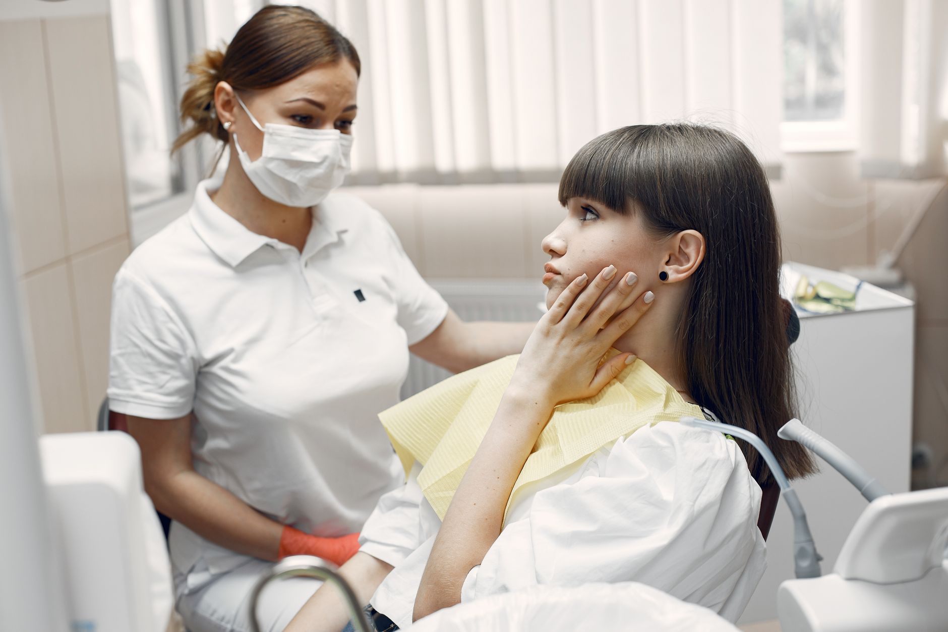 Dentist examining a patient with a toothache during a routine dental exam