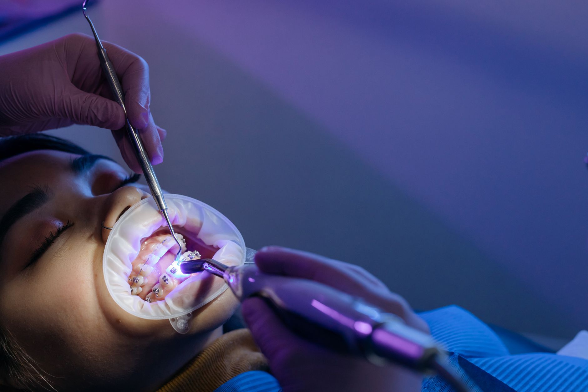 Dental professional examining a patient's jaw and bite alignment during a TMJ evaluation